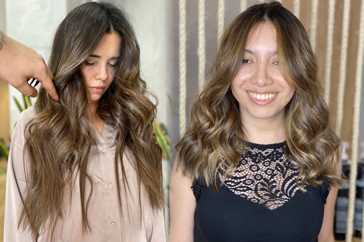 Vista de una mujer con melena larga, oscura y ondulada mostrando un brillo natural intenso tras la aplicación de barros naturales índigo.